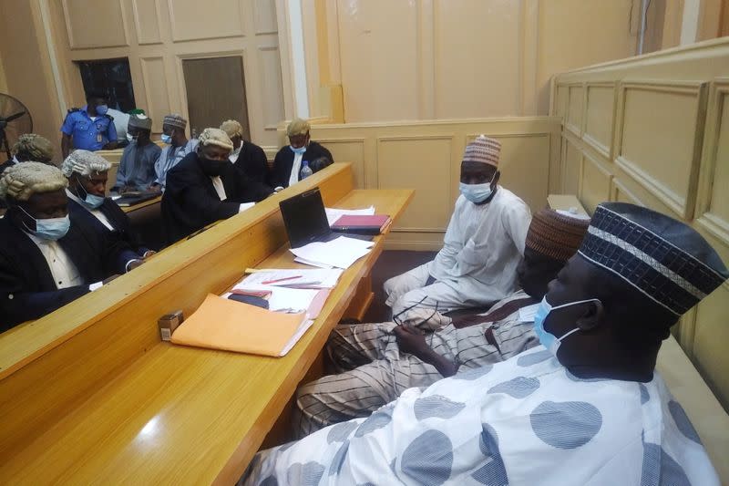 General view of a cross session of court workers facing lawyers during a hearing of a blasphemy case in Kano