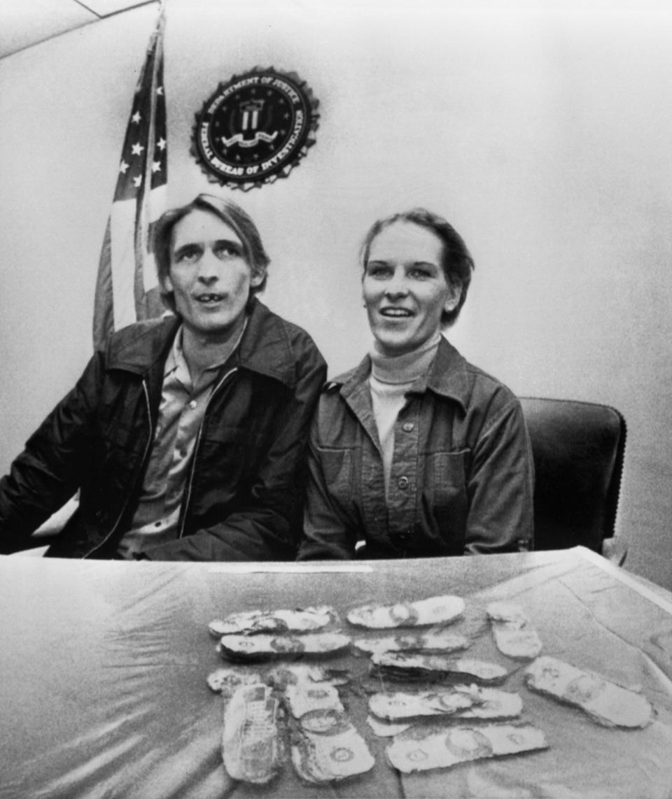 Howard and Patricia Ingram of Vancouver, Wash., sit with several thousand dollars the FBI announced was paid to legendary hijacker D.B. Cooper, on Tuesday, Feb. 12, 1980 in Portland, Ore. The couple's son Brian found the money on a picnic on Sunday. (AP Photo)