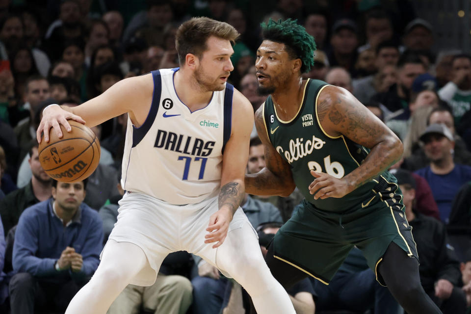 Dallas Mavericks guard Luka Doncic (77) drives against Boston Celtics guard Marcus Smart (36) during the first half of an NBA basketball game, Wednesday, Nov. 23, 2022, in Boston. (AP Photo/Mary Schwalm)