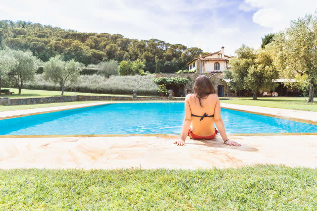 Young woman relaxing in a resort swimming pool