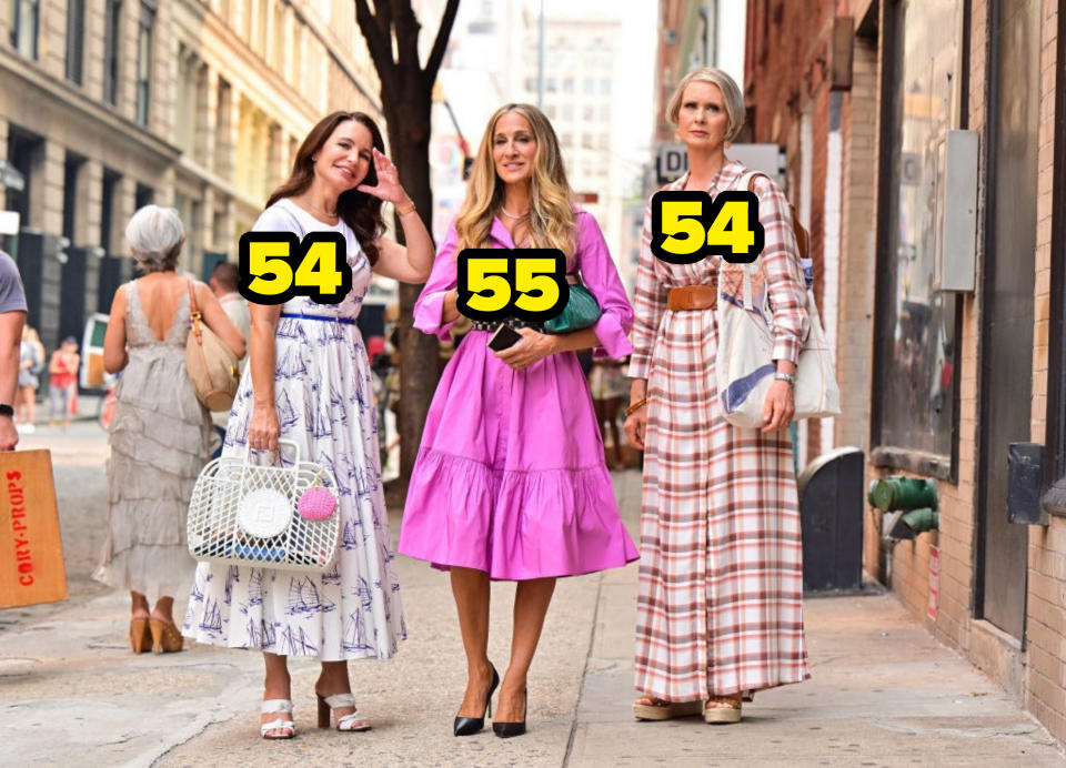 Kristin Davis, Sarah Jessica Parker, and Cynthia Nixon on a sidewalk with their ages: 54, 55, and 54