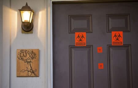 A view of the front door, which now has biohazard stickers, of the apartment where three young Muslims were killed on Tuesday, in Chapel Hill, North Carolina February 11, 2015. REUTERS/Chris Keane
