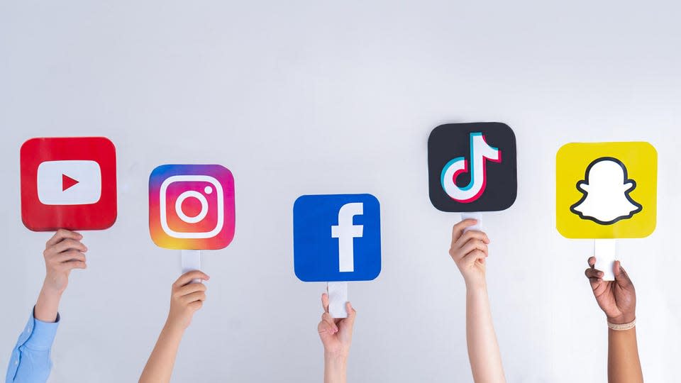 Teenagers hands hold social media signs in their hands: Youtube, Snapchat, Instagram, Tiktok, Facebook. Teenagers addicted to new technology trends - concept of youth, technology, social and friendship. Turkey, Istanbul, May 29, 2022