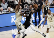 San Antonio Spurs guard DeMar DeRozan (10) scores against Milwaukee Bucks forward Thanasis Antetokounmpo, left, during the second half of an NBA basketball game in San Antonio, Monday, Jan. 6, 2020. (AP Photo/Eric Gay)
