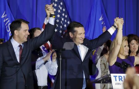 U.S. Republican presidential candidate Ted Cruz (C) celebrates with his wife Heidi and Wisconsin Governor Scott Walker (L) at his Wisconsin primary night rally in Milwaukee, Wisconsin, United States, April 5, 2016. REUTERS/Jim Young