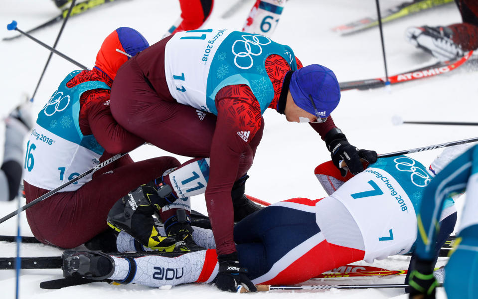 Simen Hegstad Krüger, 7, at the bottom of the pile after an early crash during Sunday’s skiathlon. (Reuters)