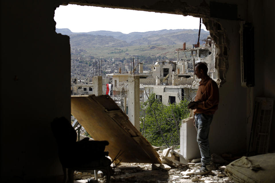 Man checks the damage at the mountain resort town in Syria