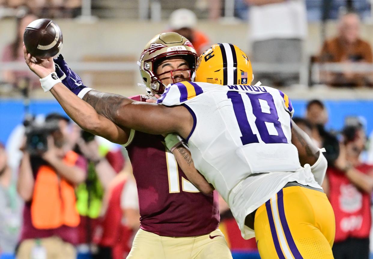 LSU's Mekhi Wingo hits Florida State QB Jordan Travis on Sept. 3, 2023 in Orlando.