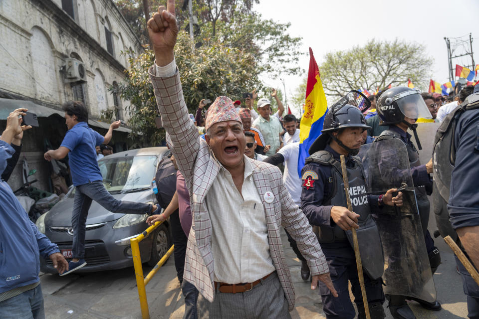 Supporters of Rastriya Prajatantra Party, or national democratic party chants slogans against the government during a protest demanding a restoration of Nepal's monarchy in Kathmandu, Nepal, Tuesday, April 9, 2024. Riot police used batons and tear gas to halt thousands of supporters of Nepal's former king demanding the restoration of the monarchy and the nation's former status as a Hindu state. Weeks of street protests in 2006 forced then King Gyanendra to abandon his authoritarian rule and introduce democracy. (AP Photo/Niranjan Shrestha)