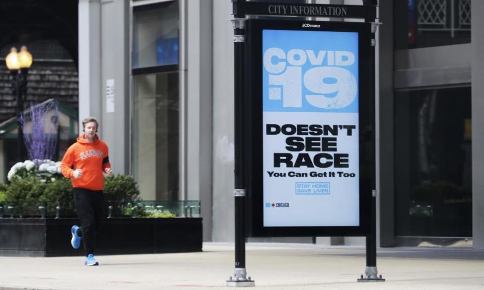 A sign warning residents of coronavirus is seen on the sidewalk in downtown Chicago.