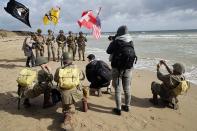 <p>Men dressed with U.S. 101st Airborne Division uniforms pose on the beach during commemorations marking the 73th anniversary of D-Day, the June 6, 1944, landings of Allied forces in Normandy. (Photo: Chesnot/Getty Images) </p>