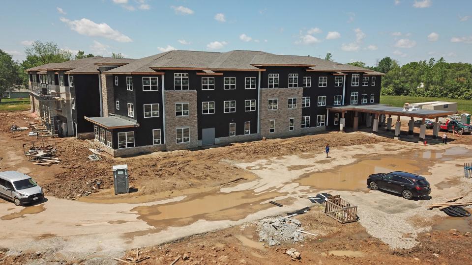 Columbus, Ohio, USA; A woman navigates the mud after an affordable housing news conference at the Touchstone Field Place apartments, 2565 Lockbourne Rd. The news conference was held Monday, May 16, 2022.