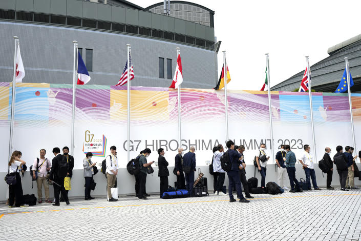 Journalists queue up to enter the International Media Center ahead of the Group of Seven (G-7) nations' meetings Thursday, May 18, 2023, in Hiroshima, western Japan. (AP Photo/Eugene Hoshiko)