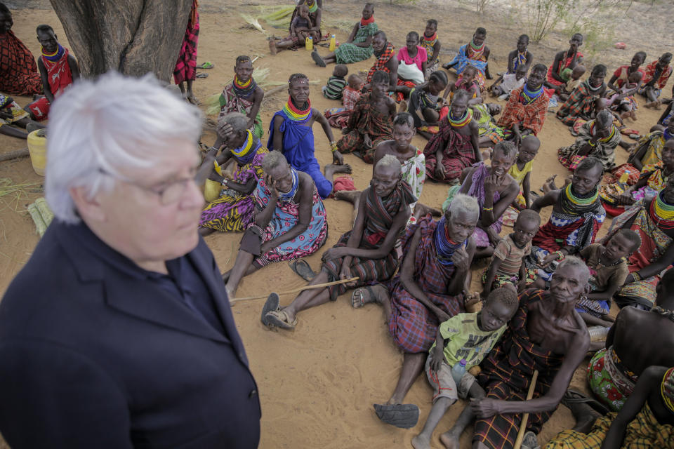 United Nations Under-Secretary-General for Humanitarian Affairs Martin Griffiths, left, meets villagers during a visit to the village of Lomoputh in northern Kenya Thursday, May 12, 2022. Griffiths visited the area on Thursday to see the effects of the drought which the U.N. says is a severe climate-induced humanitarian emergency in the Horn of Africa. (AP Photo/Brian Inganga)