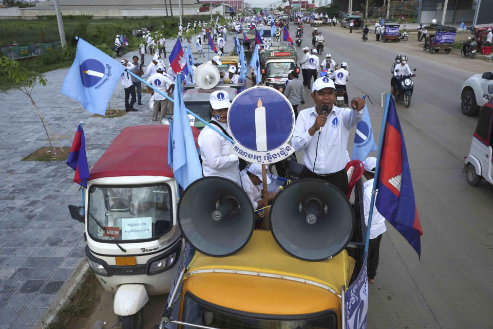 FILE - Cambodia's Candlelight Party supporters on trucks march during an election campaign for the June 5 communal elections in Phnom Penh, Cambodia, Saturday, May 21, 2022. Cambodia’s National Election Committee has announced that 20 political parties have registered for the general election in July 2023 but nine of them still have not been approved, including the Candlelight Party, the sole credible challenger to the governing Cambodian People’s Party. (AP Photo/Heng Sinith)