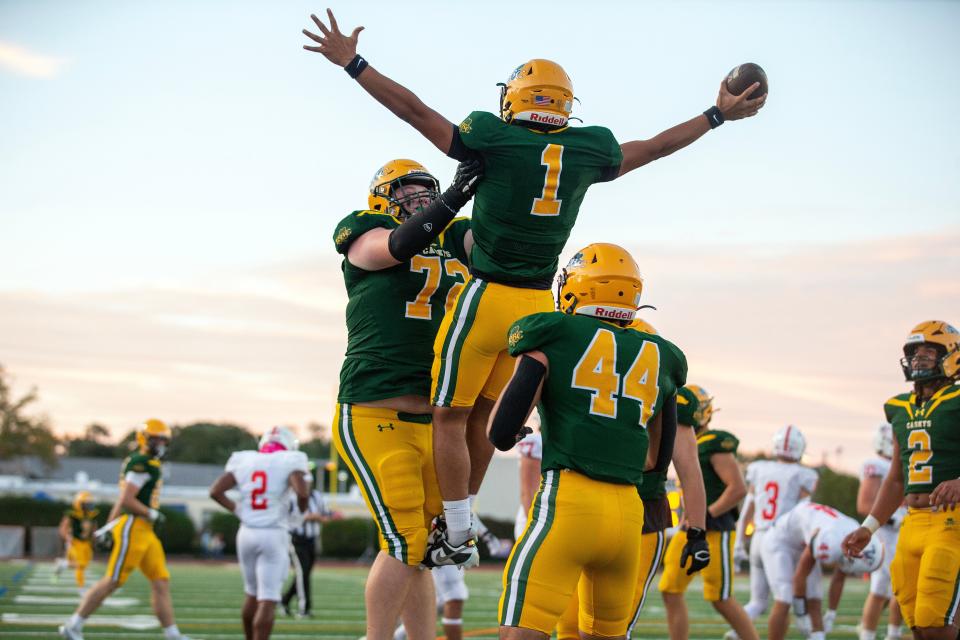 RBC's quarterback Frankie Williams celebrates a touchdown with his teammates during the first half of the Wall Township Crimson Knights vs. Red Bank Catholic Caseys high school football game at Count Basie Park in Red Bank, NJ Friday, September 15, 2023.