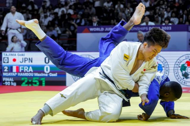 Victory: Japan's Goki Tajima defeats France's Maxime-Gael Ngayap Hambou in the teams mixed final