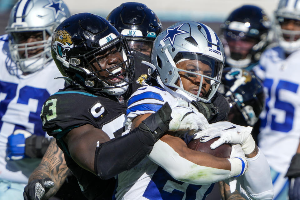 Jacksonville Jaguars linebacker Foyesade Oluokun (23) tackles Dallas Cowboys running back Tony Pollard (20) for no gain during the first half of an NFL football game, Sunday, Dec. 18, 2022, in Jacksonville, Fla. (AP Photo/John Raoux)