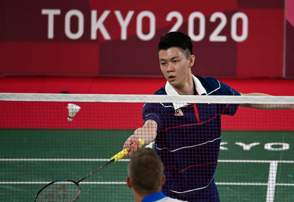 Malaysia’s Lee Zii Jia hits a shot to France’s Brice Leverdez in their men’s singles badminton group stage match during the Tokyo 2020 Olympic Games at the Musashino Forest Sports Plaza in Tokyo July 28, 2021. — AFP pic