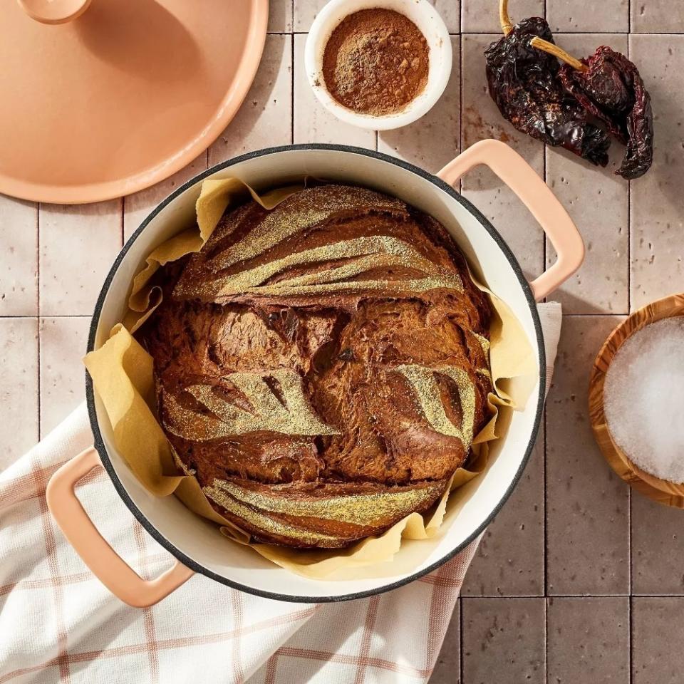 Freshly baked bread in an orange Dutch oven