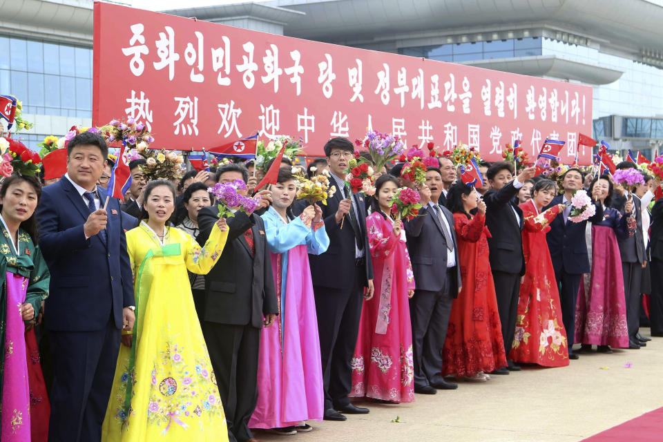 Pyongyang citizens welcome a Chinese delegation headed by Zhao Leji, chairman of the National People’s Congress and considered the No. 3 official in the ruling Communist Party, as they arrive at the Pyongyang International Airport in Pyongyang, North Korea, Thursday, April 11, 2024. The banner in the background says, "Warmly welcome the party and government delegation of the People's Republic of China!" (AP Photo/Cha Song Ho)