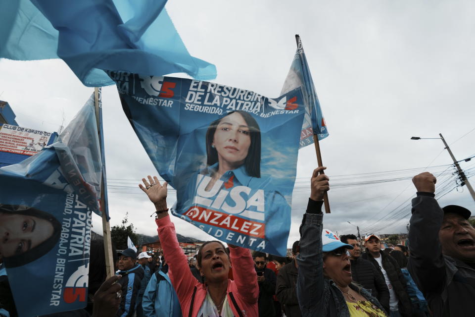 Supporters of Presidential candidate Luisa González, of the Citizen's Revolution Political Movement, gather at dusk to wait for the electoral results after polls closed during a snap election, Quito, Ecuador, Sunday, Aug. 20, 2023. The election was called after President Guillermo Lasso dissolved the National Assembly by decree in May to avoid being impeached. (AP Photo/Dolores Ochoa)