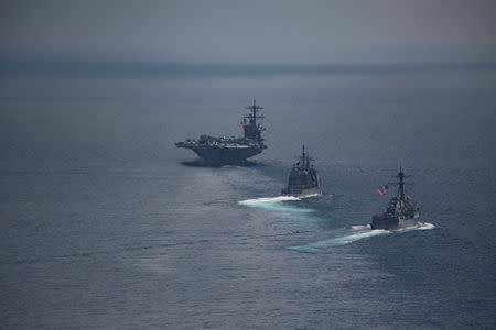 The USS Carl Vinson (CVN 70), front, leads the Arleigh Burke-class guided-missile destroyer USS Michael Murphy (DDG 112 and the Ticonderoga-class guided-missile cruiser USS Lake Champlain (CG 57), in the Indian ocean April 14, 2017. U.S. Navy photo by Mass Communication Specialist 3rd Class Danny Kelley/Handout via REUTERS