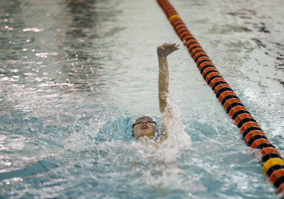 Arlington High School's Kevin Ma competes in the 100 backstroke during Friday's meet against Our Lady of Lourdes held at Marlboro High School on January 21, 2022.
