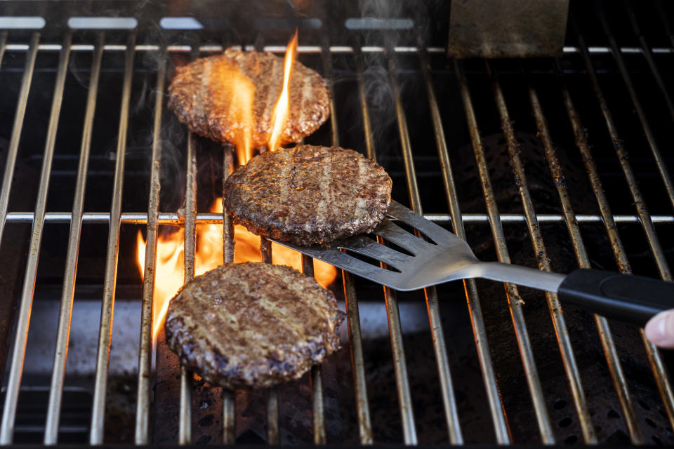 burgers cooking on a grill