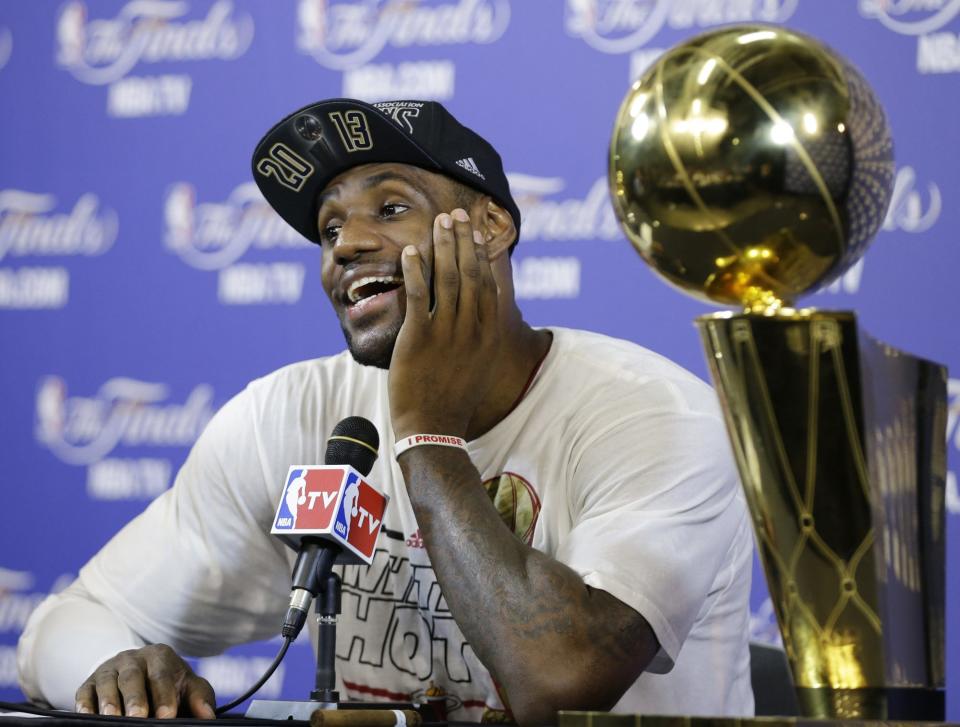 The Miami Heat's LeBron James smiles during a post game news conference following Game 7 of the NBA basketball championship game against the San Antonio Spurs, Friday, June 21, 2013, in Miami. The Miami Heat defeated the San Antonio Spurs 95-88 to win their second straight NBA championship.