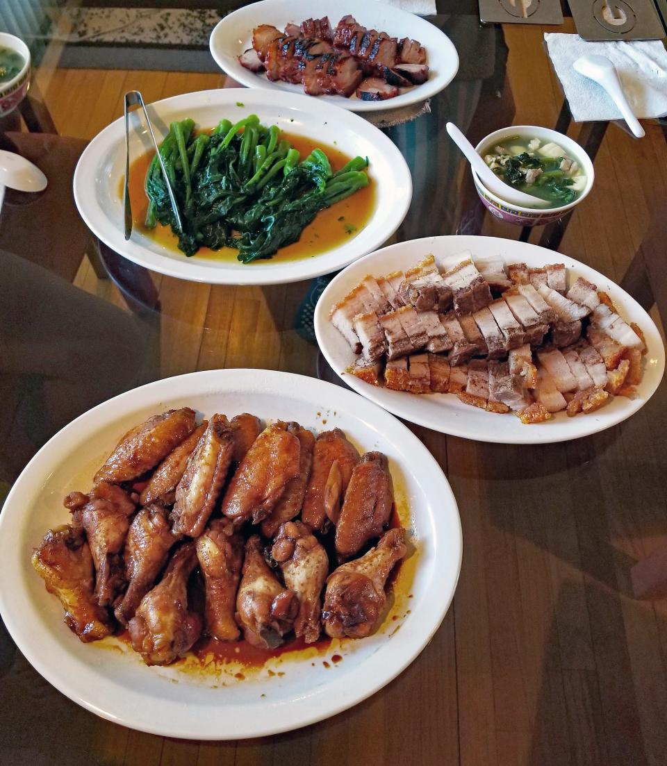 Mabel sometimes makes a big spread for special occasions. From top, barbecue roast pork, Chinese broccoli with oyster sauce, watercress and tofu soup, crispy pork belly and soy sauce chicken wings.