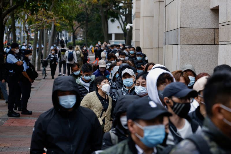 People queue outside the West Kowloon Magistrates' Courts building during the hearing of the 47 pro-democracy activists charged with conspiracy to commit subversion under the national security law, in Hong Kong