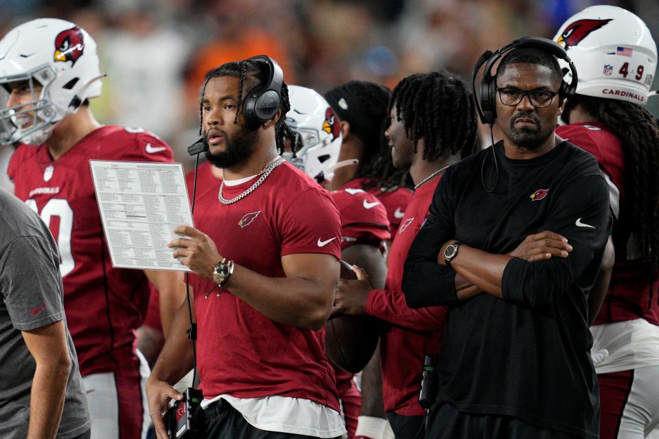 Arizona Cardinals quarterback Kyler Murray, center right, stands on the sidelines during an NFL football game against the Cincinnati Bengals Friday, Aug. 12, 2022, in Cincinnati. (AP Photo/Jeff Dean)