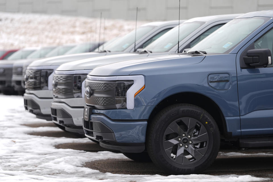 Unsold 2024 F150 Lightning electric pickup trucks sit in a long row at a Ford dealership Sunday, Jan. 21, 2024, in Broomfield, Colo. (AP Photo/David Zalubowski)