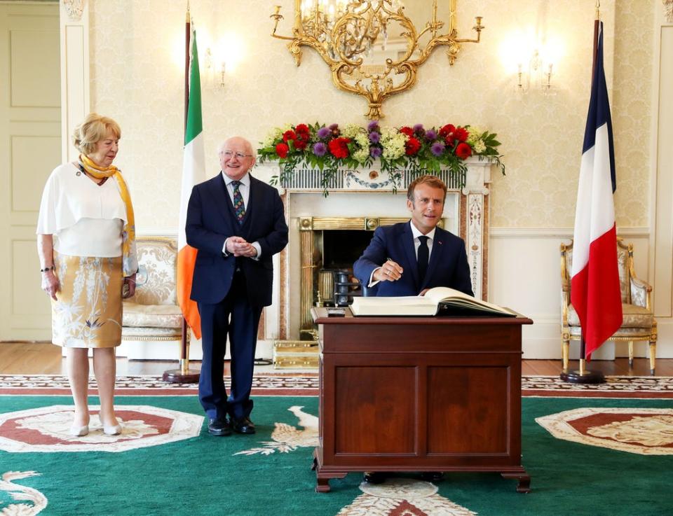 French President Emmanuel Macron signing the guestbook at Aras an Uachtarain, Dublin (Maxwells/PA) (PA Media)