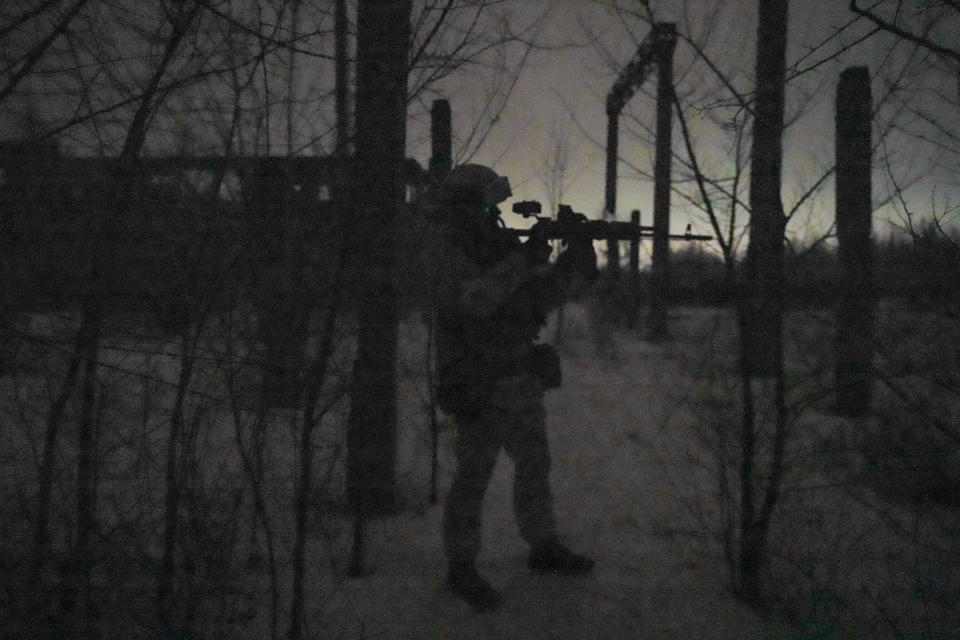 Ukrainian serviceman Ivan Skuratovskyi looks through a weapon mounted night-vision device during a night tour of frontline positions outside Avdiivka, Donetsk region, eastern Ukraine, Friday, Feb. 4, 2022. From his front-line vantage point, Skuratovskyi, who recently reupped with the army for another two years, agrees with the president's diplomacy-focused approach and said he sees no armed solution to the standoff. “Weapons won’t solve any problem here,” he says. (AP Photo/Vadim Ghirda)