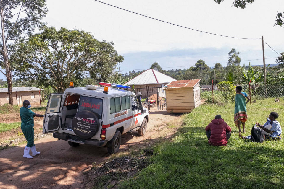 A medical officer from the Uganda Red Cross Society instructs people with suspected Ebola symptoms to enter an ambulance, in Madudu, near Mubende, in Uganda, Thursday, Sept. 29, 2022. In this remote Ugandan community facing its first Ebola outbreak, testing trouble has added to the challenges with symptoms of the Sudan strain of Ebola now circulating being similar to malaria, underscoring the pitfalls health workers face in their response. (AP Photo/Hajarah Nalwadda)