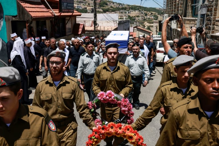 Mourners at the northern Israel funeral of one of eight soldiers killed in a blast near Gaza's Rafah (Menahem Kahana)