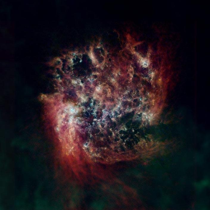 The Large Magellanic Cloud (LMC) is a satellite of the Milky Way, containing about 30 billion stars. Seen here in a far-infrared and radio view, the LMC’s cool and warm dust are shown in green and blue, respectively, with hydrogen gas in red.