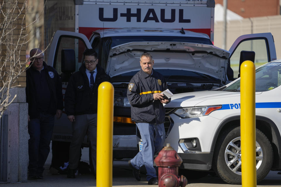 New York Police chief of intelligence Thomas Galati, right, investigates the scene where a rental truck was stopped and the driver arrested, Monday, Feb. 13, 2023, in New York. Authorities say a man driving a U-Haul truck struck and injured several pedestrians in New York City before police were able to pin the careening vehicle against a building following a mileslong pursuit through Brooklyn. (AP Photo/John Minchillo)