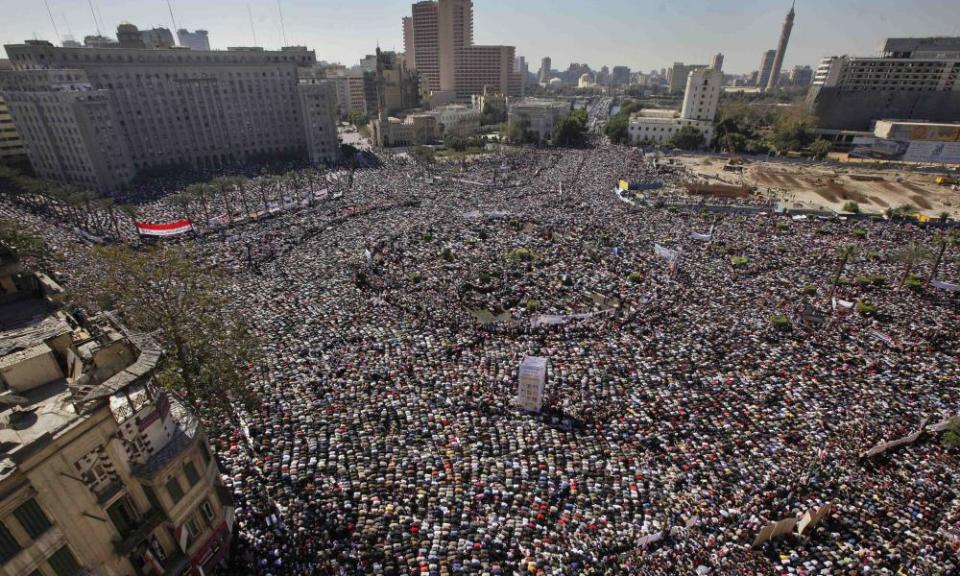 Egyptians in Tahrir Square, Cairo, pray and celebrate the fall of the regime of former President Hosni Mubarak in February 2011.
