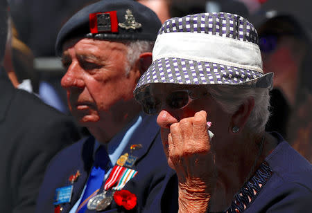 Veterans and relatives react as they listen during a memorial service at the ANZAC Memorial to mark the centenary of the Armistice ending World War One, in Sydney, Australia, November 11, 2018. REUTERS/David Gray