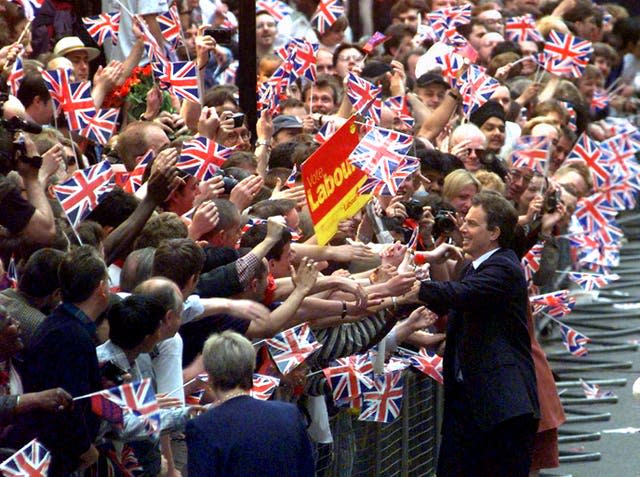 Tony Blair pictured in 1997, greeting hundreds of UK flag-waving supporters