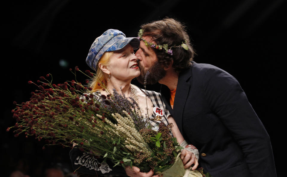 British fashion designer Vivienne Westwood is kissed by her husband Andreas Kronthaler after presenting the Vivienne Westwood fashion collection, from the men's Spring-Summer 2013 collection, part of the Milan Fashion Week, unveiled in Milan, Italy, Sunday, June 24, 2012. (AP Photo/Luca Bruno)