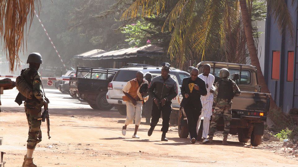 People run to flee from the Radisson Blu Hotel in Bamako, Mali. Photo: AP Photo/Harouna Traore