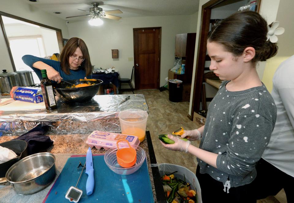 Sister of Rabbi Turen, Moussia Turen, 12, of Chicago, right, and mother of Rabbi Turen, also of Chicago, work on the passover meal in the Rabbi's home in Springfield Tuesday, April 4, 2023.