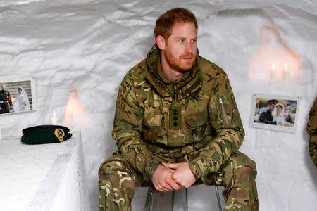 Britain's Prince Harry, Captain General Royal Marines, sits in a snow cave decorated with candles and his wedding photos, during Exercise Clockwork, celebrating 50 years of cold weather military training at Bardufoss Air Station, Norway February 14, 2019. NTB Scanpix/Rune Stoltz Bertinussen via REUTERS