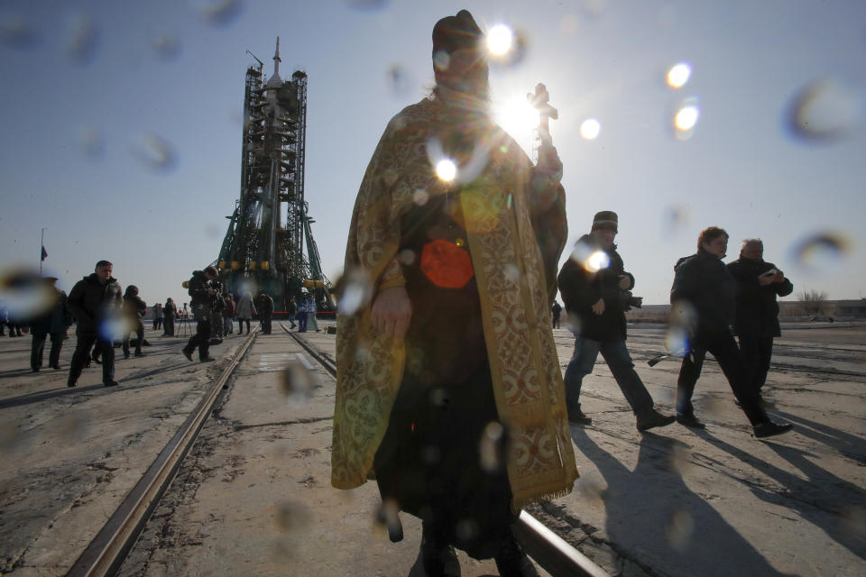 An Orthodox priest walks after a blessing service in front of the Soyuz FG rocket at the Russian leased Baikonur cosmodrome, Kazakhstan, Thursday, March 14, 2019. The new Soyuz mission to the International Space Station (ISS) is scheduled on Thursday, March 14 with U.S. astronauts Christina Hammock Koch, Nick Hague, and Russian cosmonaut Alexey Ovchinin. (AP Photo/Dmitri Lovetsky)