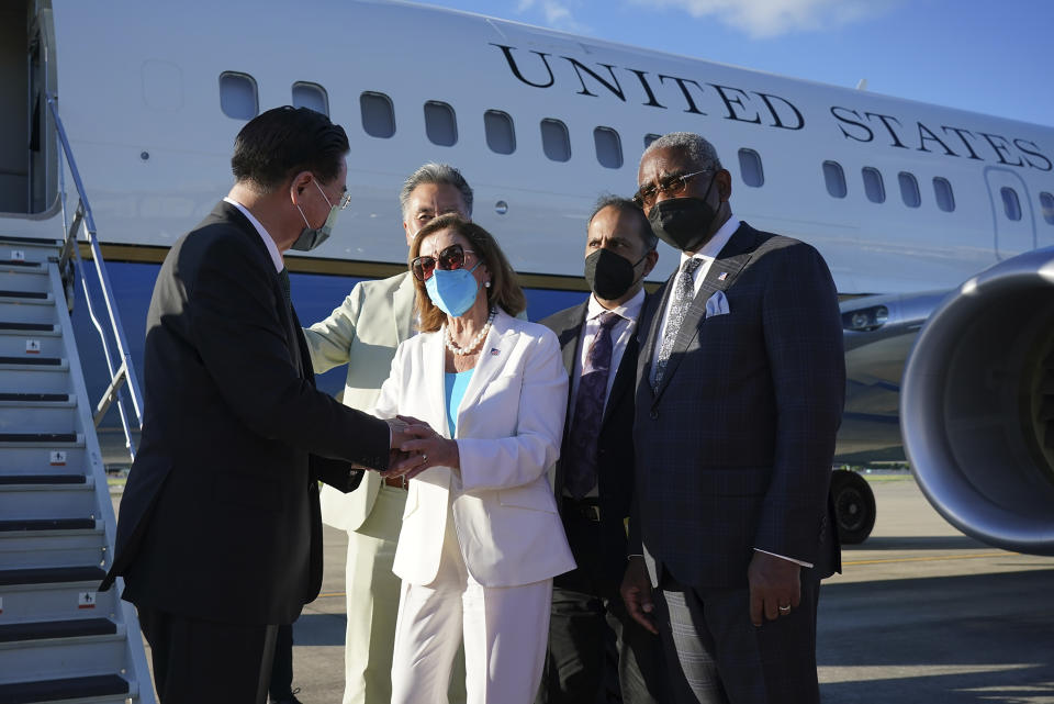 In this photo released by Taiwan's Ministry of Foreign Affairs, Taiwan's Foreign Minister Joseph Wu, left, speaks with U.S. House Speaker Nancy Pelosi as she prepares to leave in Taipei, Taiwan, Wednesday, Aug. 3, 2022. Pelosi left Taiwan after a visit that heightened tensions with China, saying Wednesday that she and other members of Congress in her delegation showed they will not abandon their commitment to the self-governing island. (Taiwan Ministry of Foreign Affairs via AP)