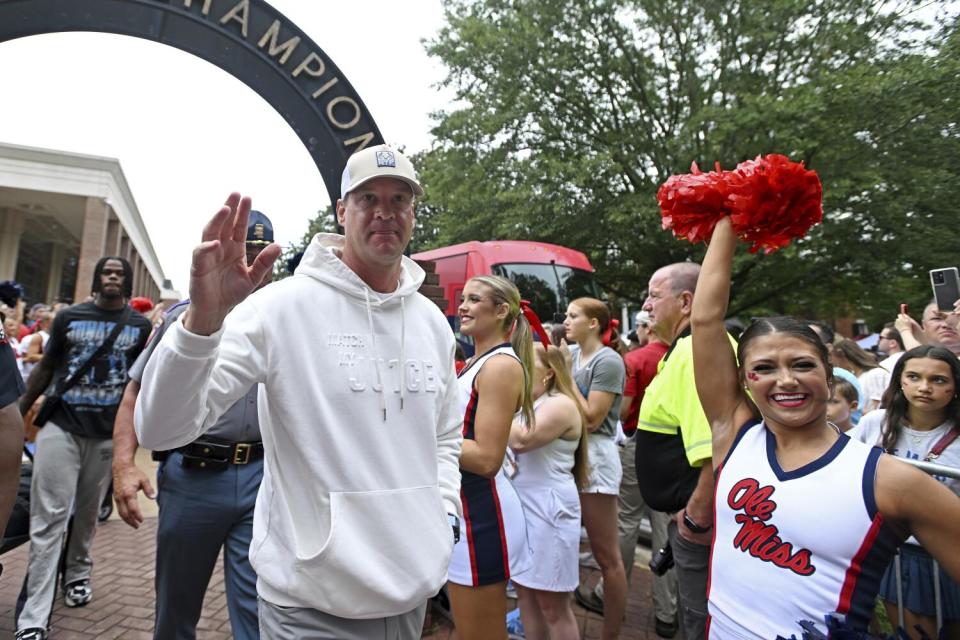 Mississippi coach Lane Kiffin waves to fans during the Walk of Champions.